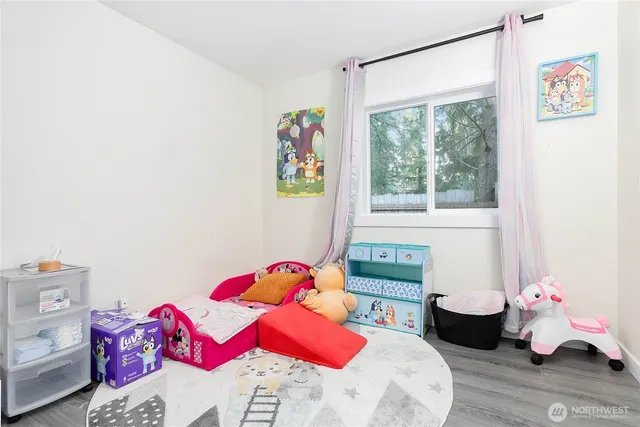 a bedroom with a bed a couch and a window