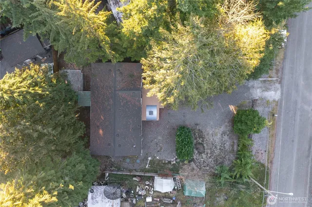 an aerial view of a house with yard and outdoor seating