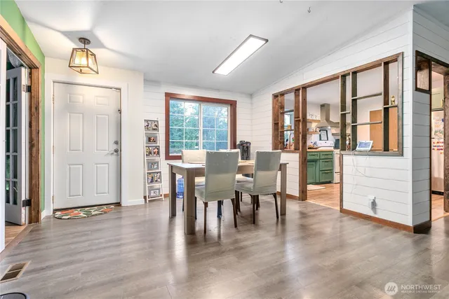 a view of a dining room with furniture and wooden floor