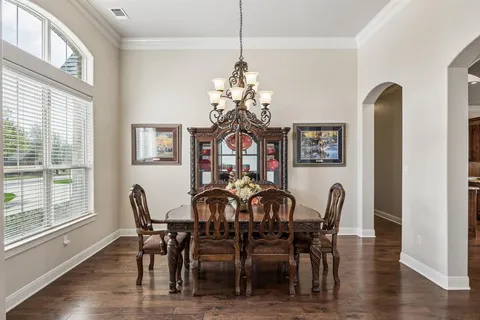 a view of a dining room with furniture wooden floor and chandelier
