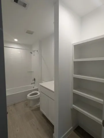 a bathroom with a toilet a sink and bathtub