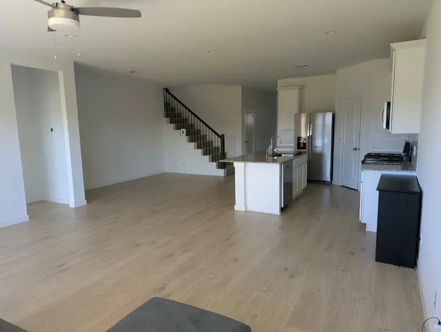 a view of a kitchen with furniture and staircase