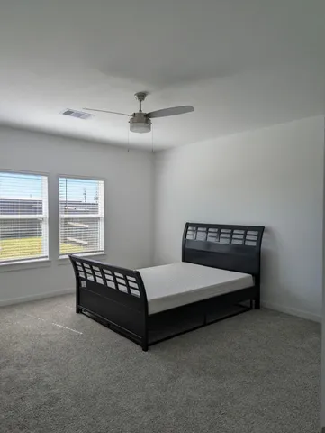 a bedroom with a bed and window