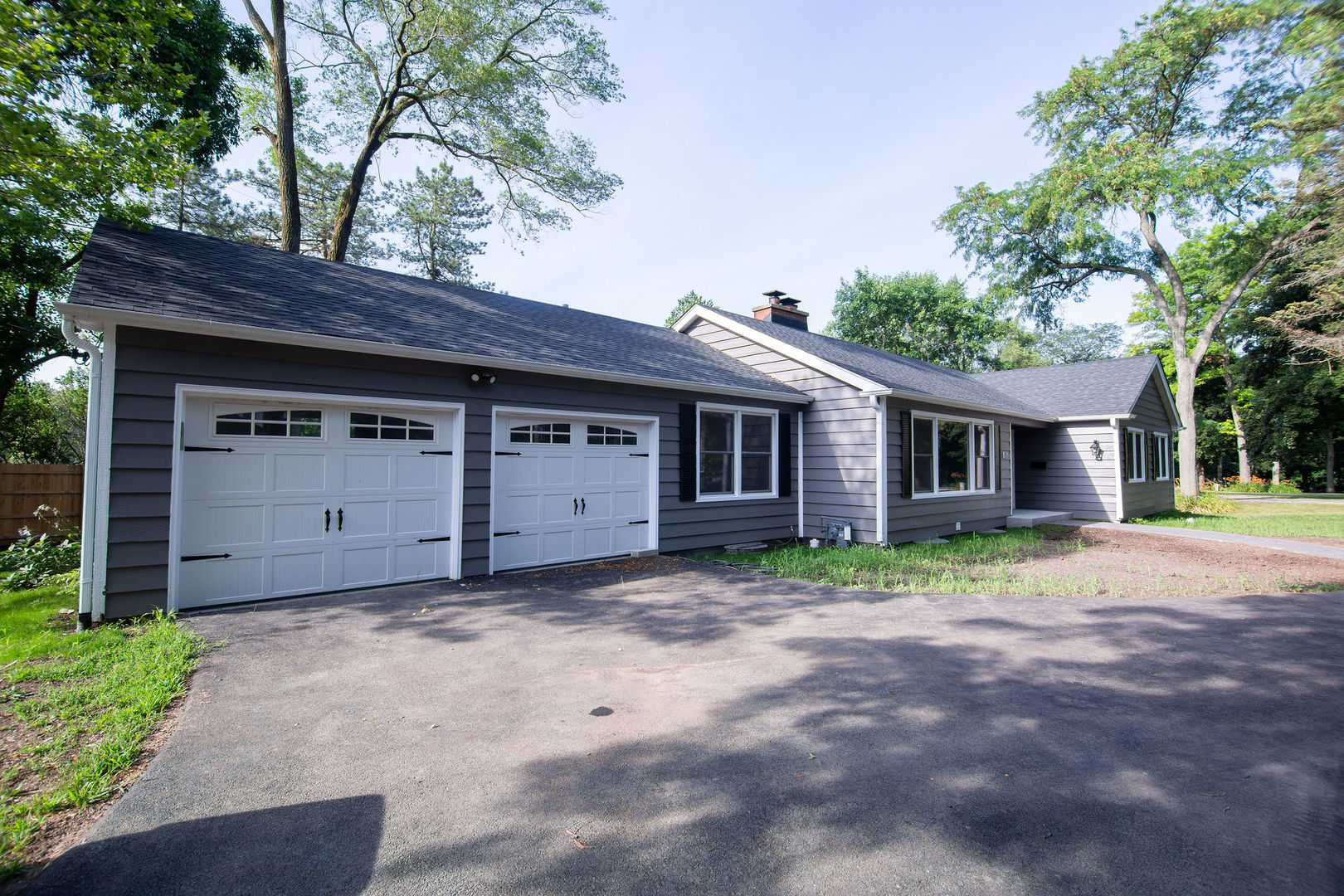 653 Elm Road Barrington, IL 60010 - Photo 1 of 1 a view of a house with a large tree and wooden fence