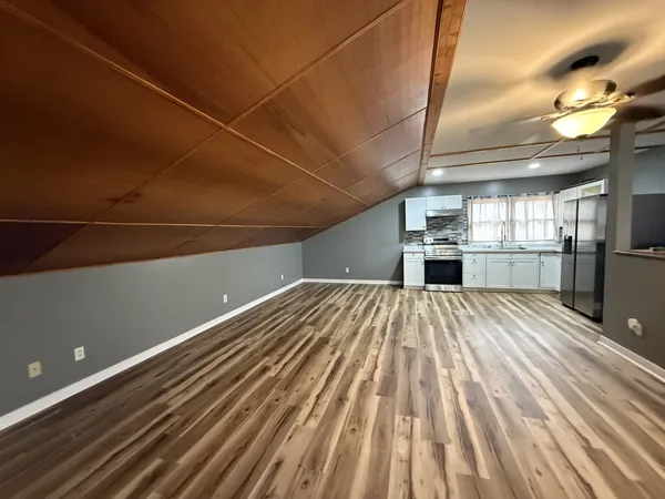 a view of a room with wooden floor