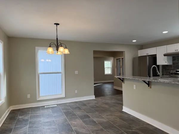 a view of a kitchen with a sink cabinets and a wooden floor