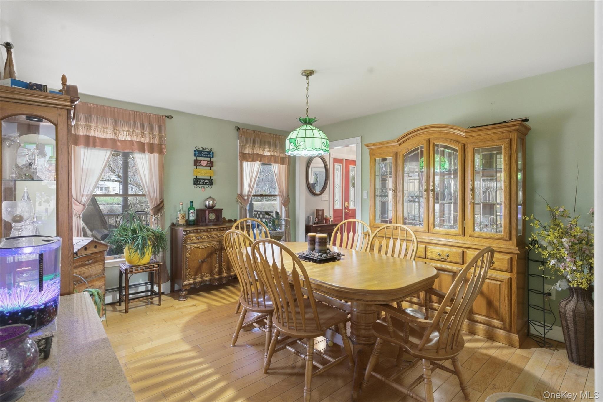 1285 Lakes Road Monroe, NY 10950 - Photo 10 of 45 a dining room with furniture a chandelier and wooden floor