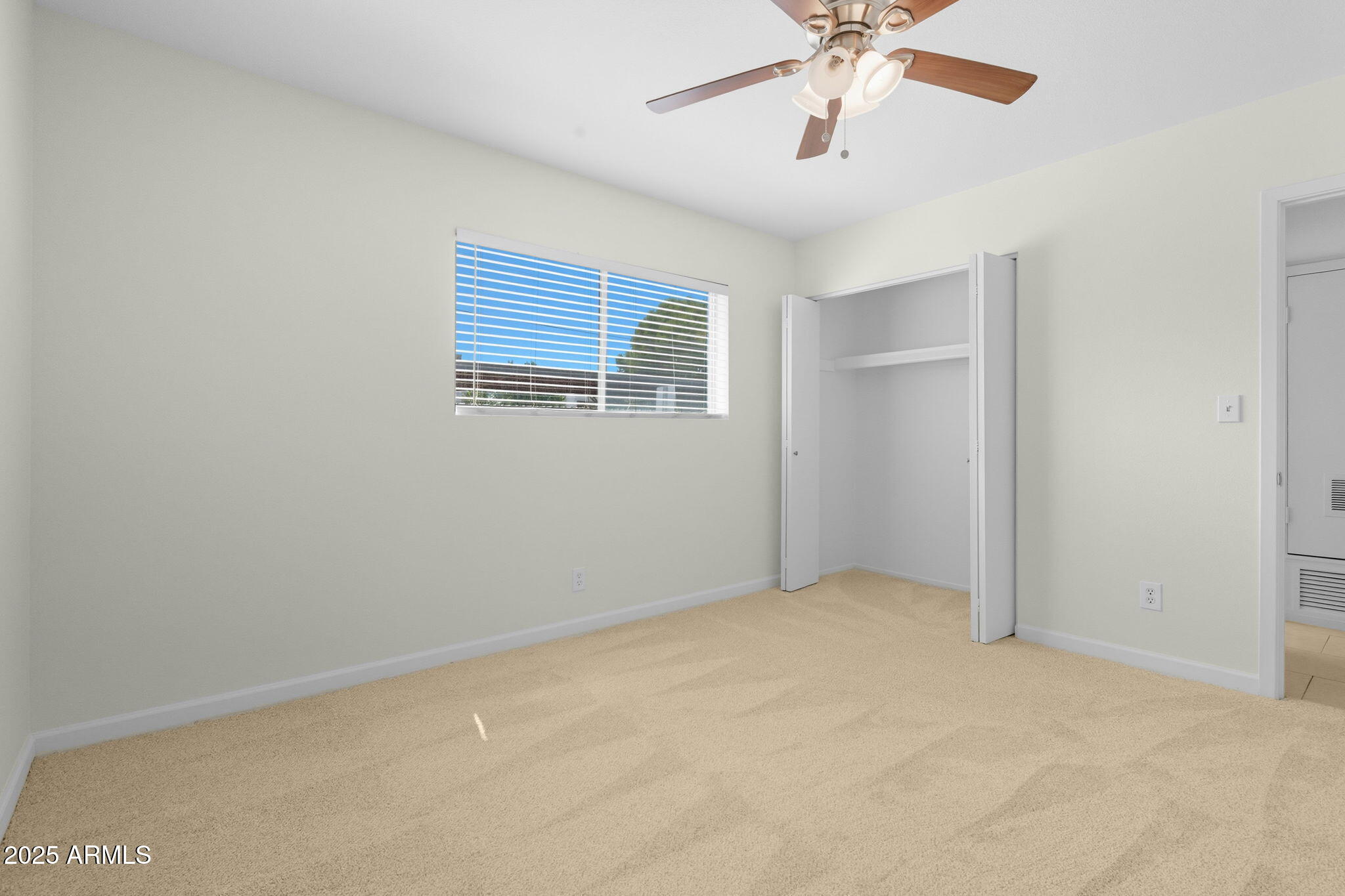 749 East Montebello Avenue, Unit 127 Phoenix, AZ 85014 - Photo 13 of 20 an empty room with chandelier fan