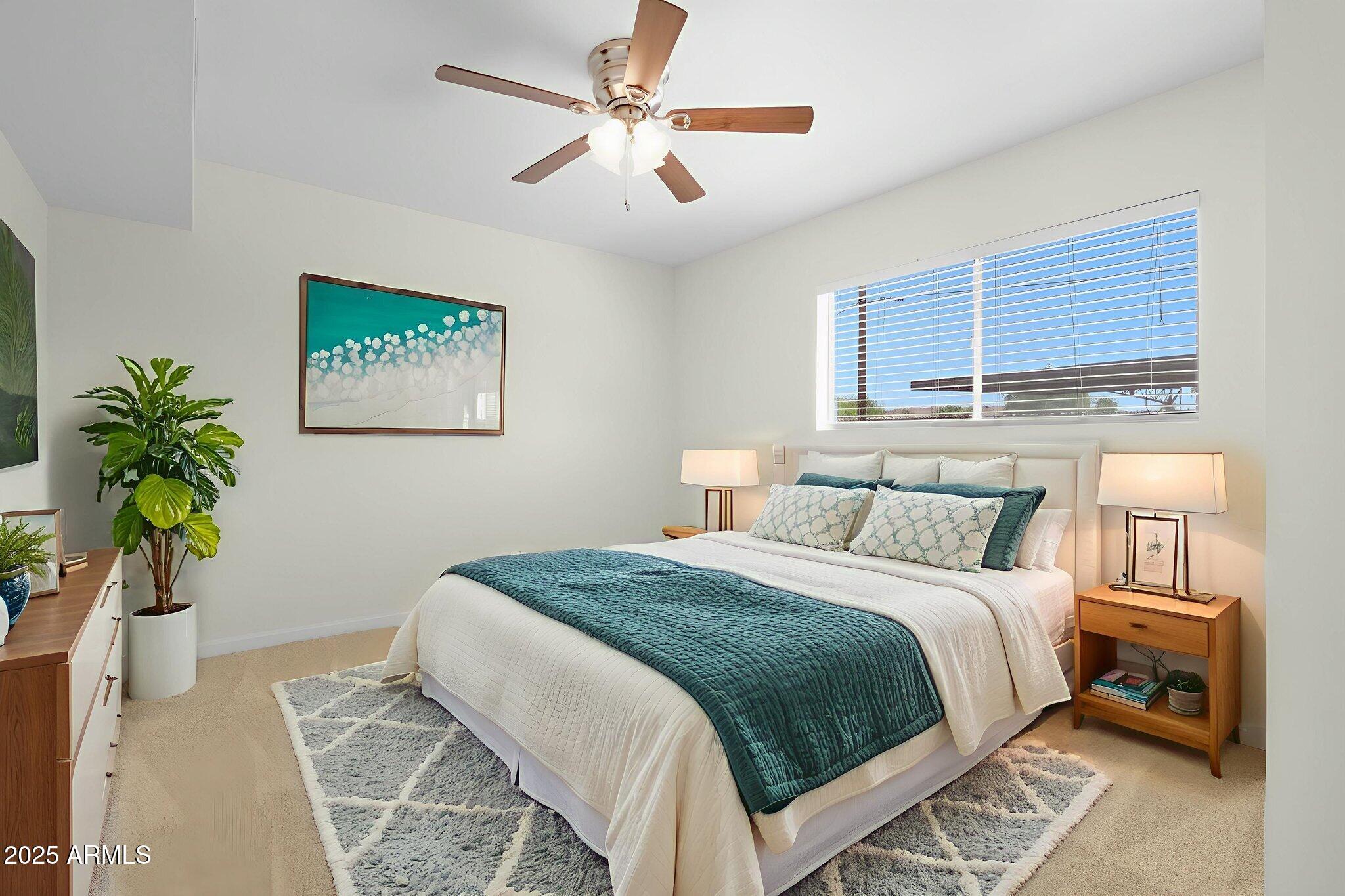 749 East Montebello Avenue, Unit 127 Phoenix, AZ 85014 - Photo 2 of 20 a bedroom with a bed and a chandelier