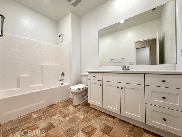 a view of a livingroom with a ceiling fan and window