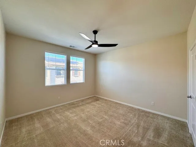 a view of a livingroom with a ceiling fan and window