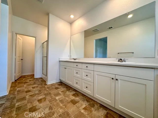a bathroom with a glass shower door