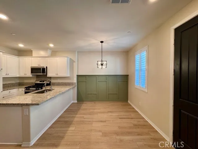 a view of a kitchen with a sink and a chandelier