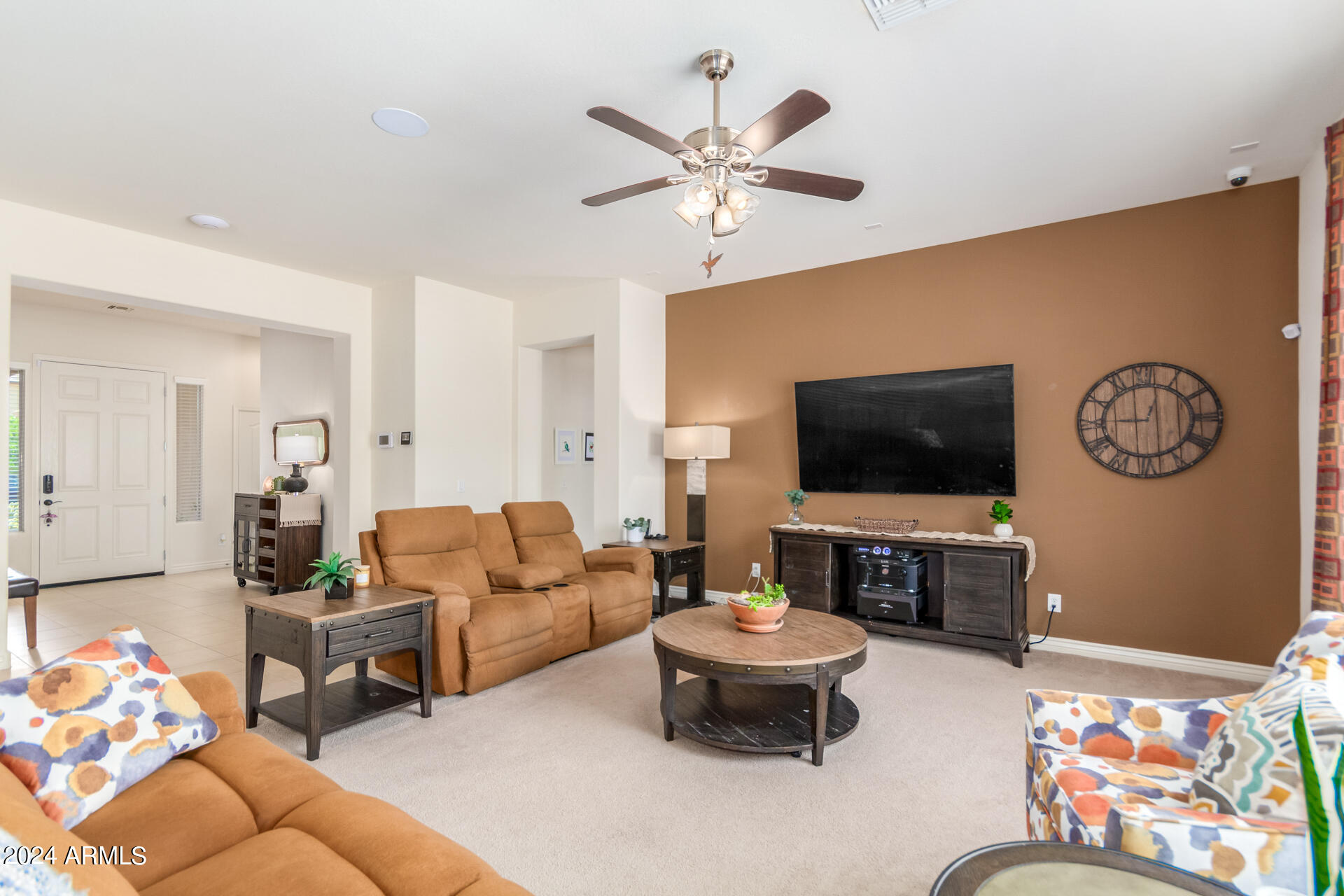 17858 West Verdin Road Goodyear, AZ 85338 - Photo 10 of 78 a living room with furniture a flat screen tv and a couch
