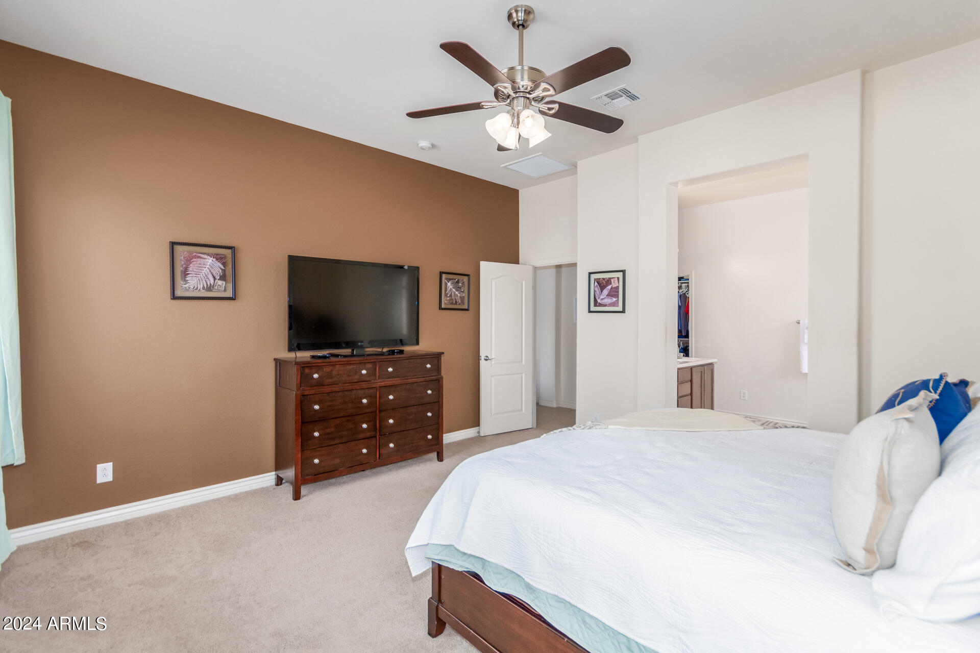 17858 West Verdin Road Goodyear, AZ 85338 - Photo 20 of 78 a bedroom with a bed and a flat screen tv