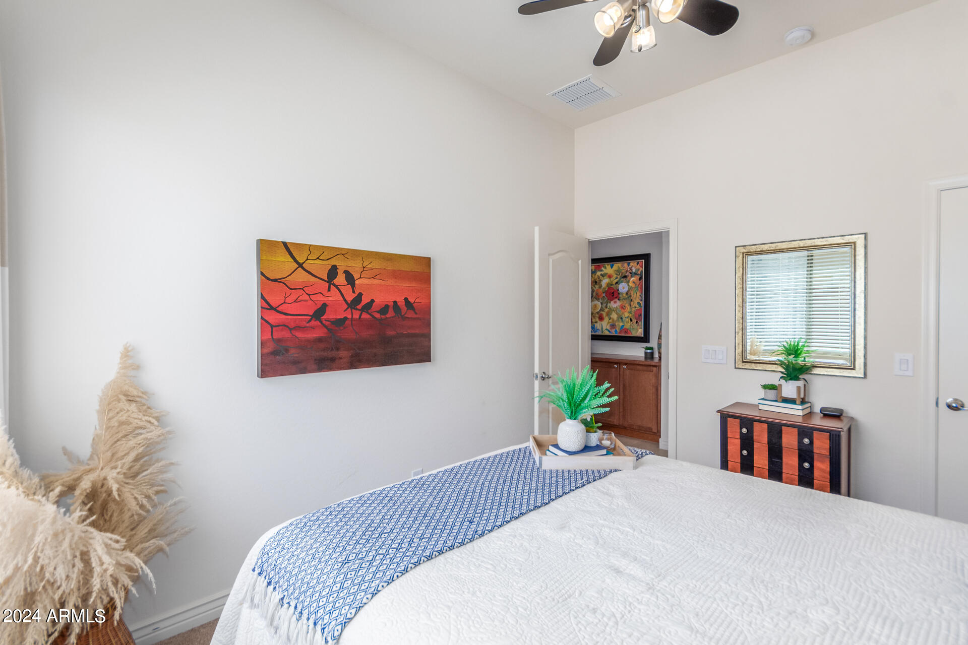 17858 West Verdin Road Goodyear, AZ 85338 - Photo 24 of 78 a bedroom with a bed a painting on the wall and a window