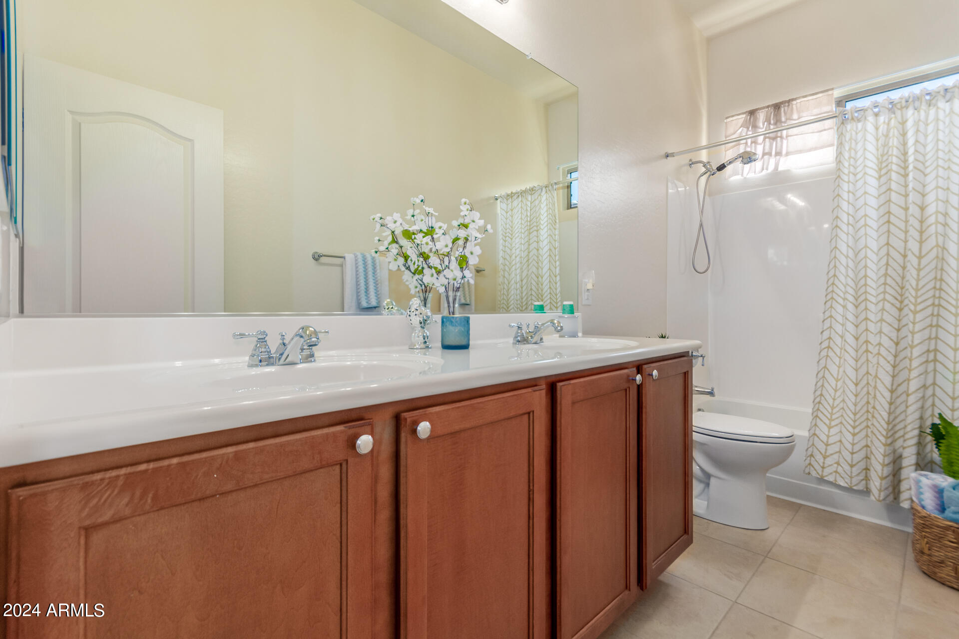 17858 West Verdin Road Goodyear, AZ 85338 - Photo 25 of 78 a bathroom with a granite countertop sink a toilet and a mirror