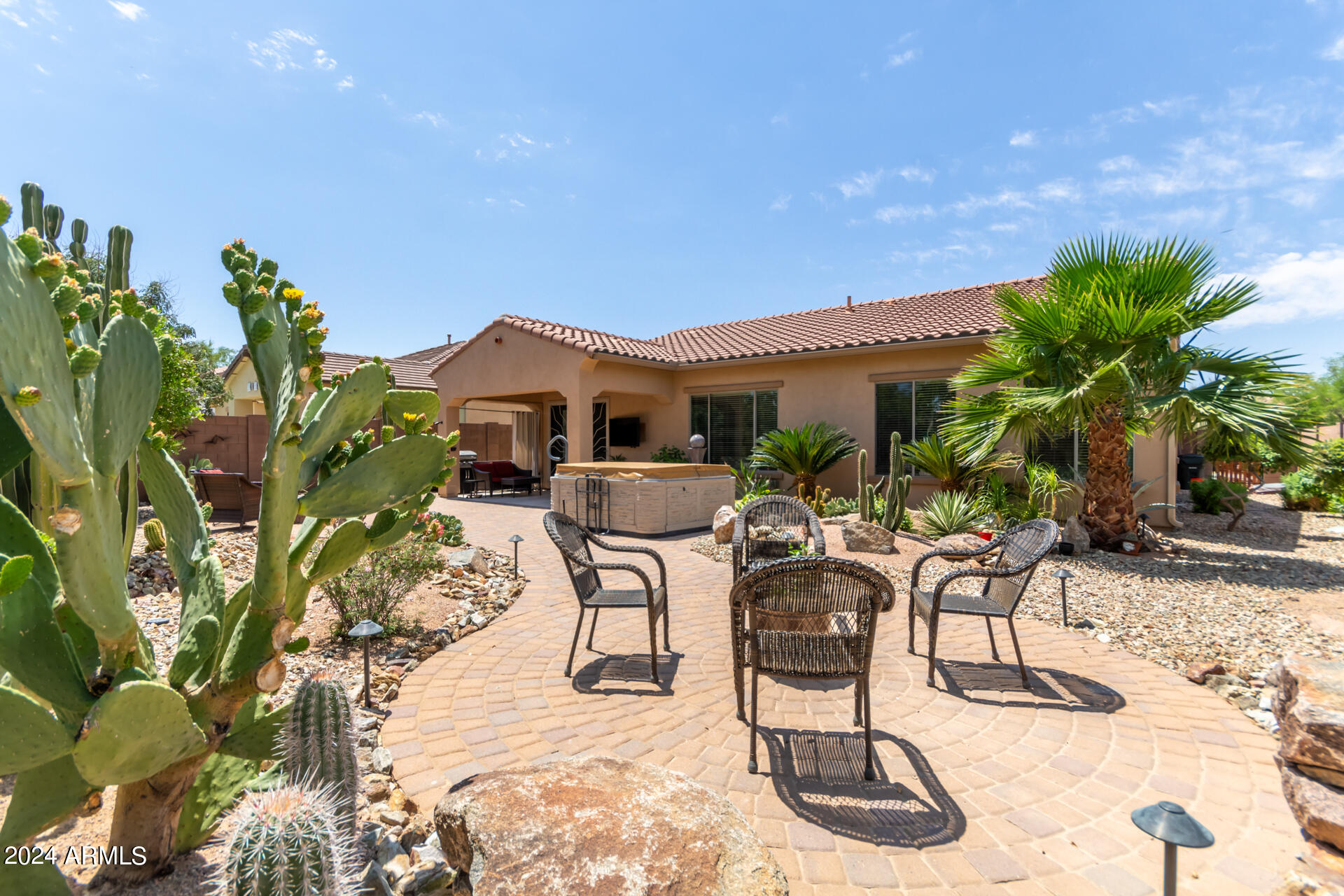 17858 West Verdin Road Goodyear, AZ 85338 - Photo 32 of 78 a view of a patio with table and chairs potted plants and palm tree