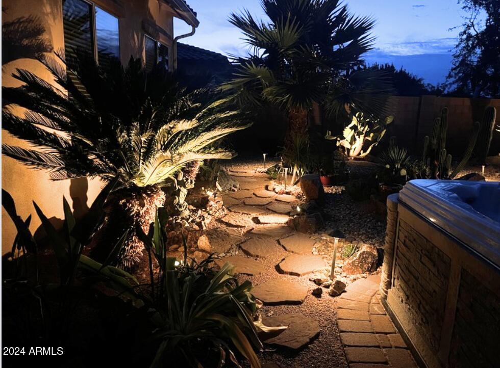 17858 West Verdin Road Goodyear, AZ 85338 - Photo 37 of 78 a backyard of a house with table and chairs under an umbrella