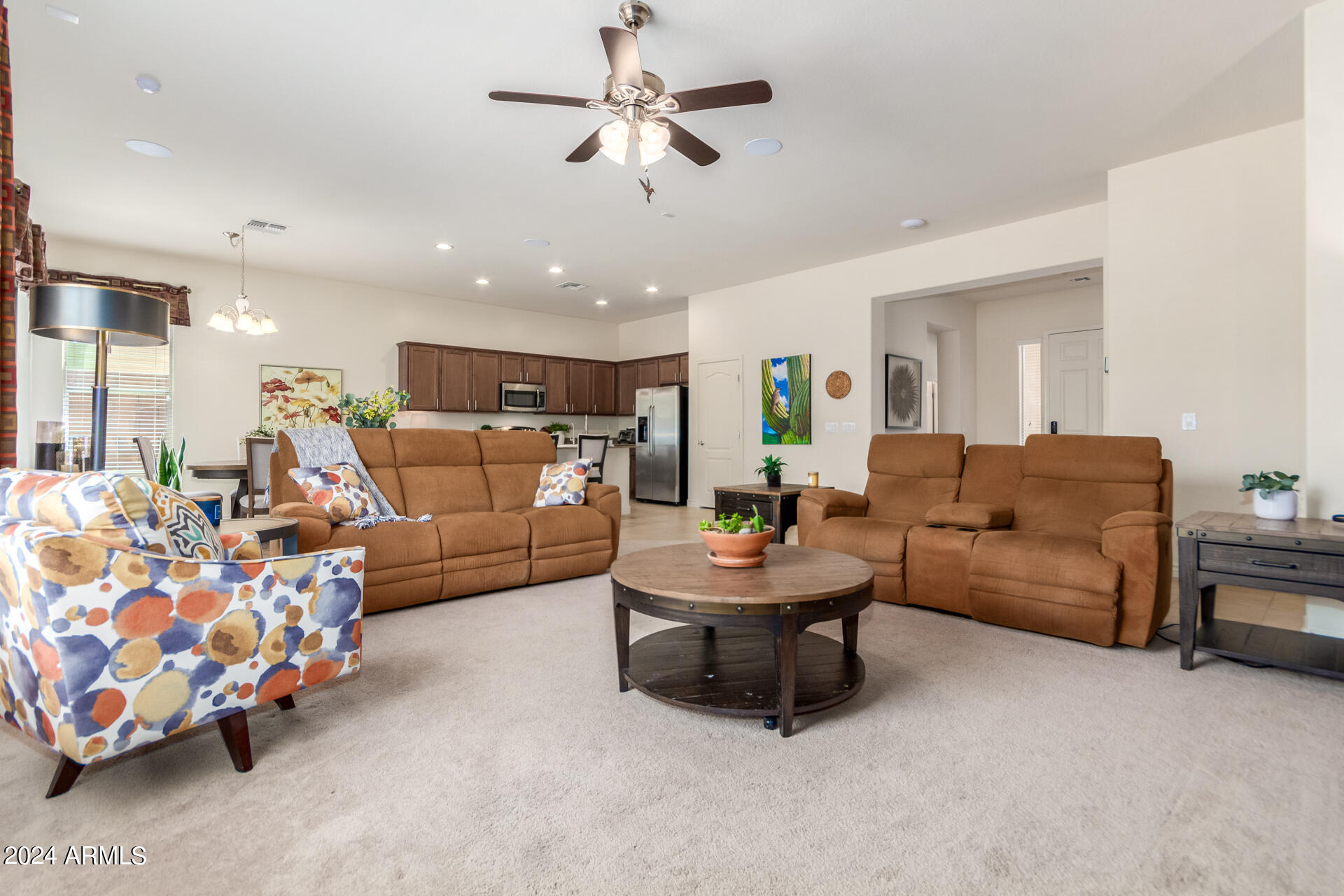 17858 West Verdin Road Goodyear, AZ 85338 - Photo 78 of 78 a living room with furniture and a chandelier