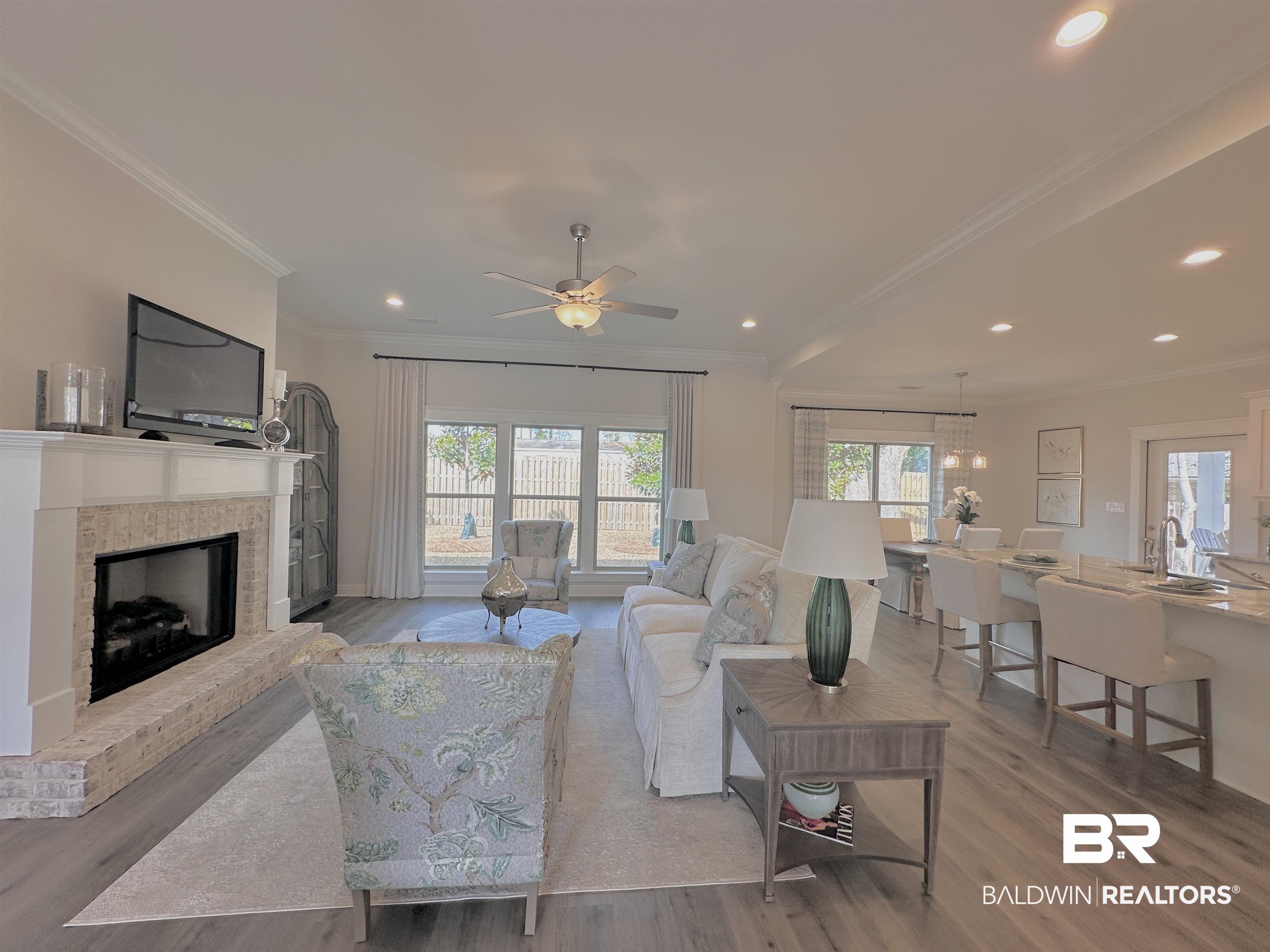 691 Kitfox Avenue Fairhope, AL 36532 - Photo 2 of 42 Living room with crown molding, sink, light hardwood / wood-style floors, and a brick fireplace
