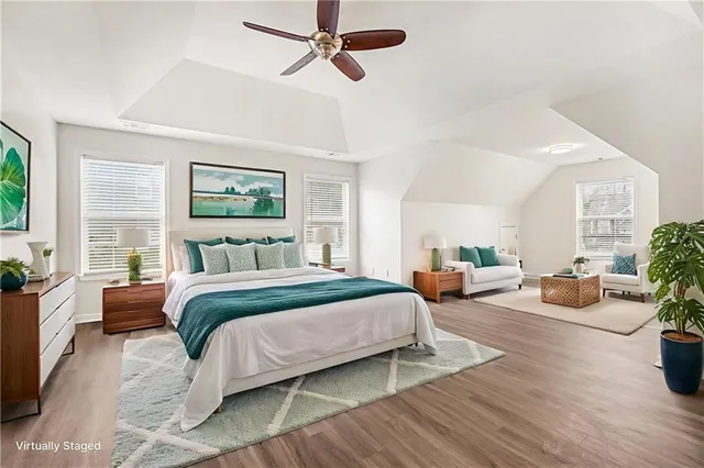 a bedroom with bed and wooden floor
