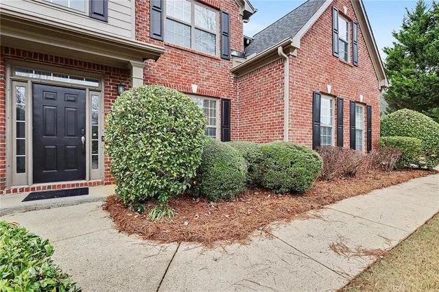 a front view of a house with garden