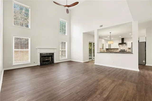 a view of empty room with wooden floor and fireplace