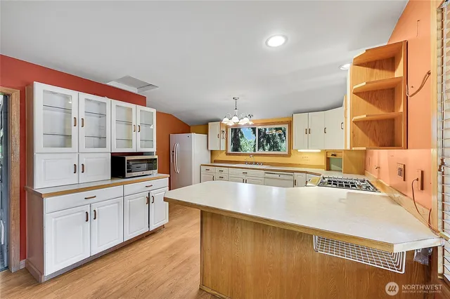 a kitchen with stainless steel appliances granite countertop a sink and cabinets