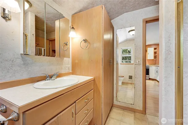 a bathroom with a sink a mirror and a shower