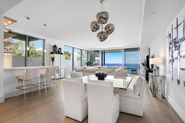 a kitchen with a table chairs refrigerator and microwave