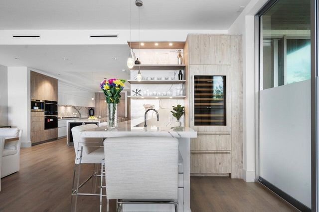 a view of a room with a large window and wooden floor