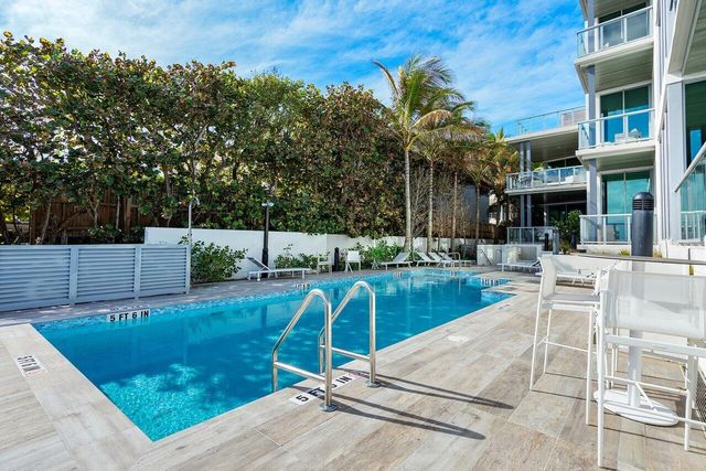 a view of a house with a porch and a yard