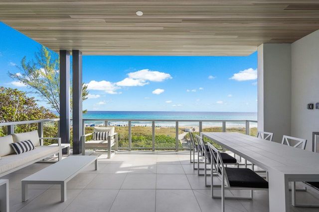 a view of a patio with a table and chairs