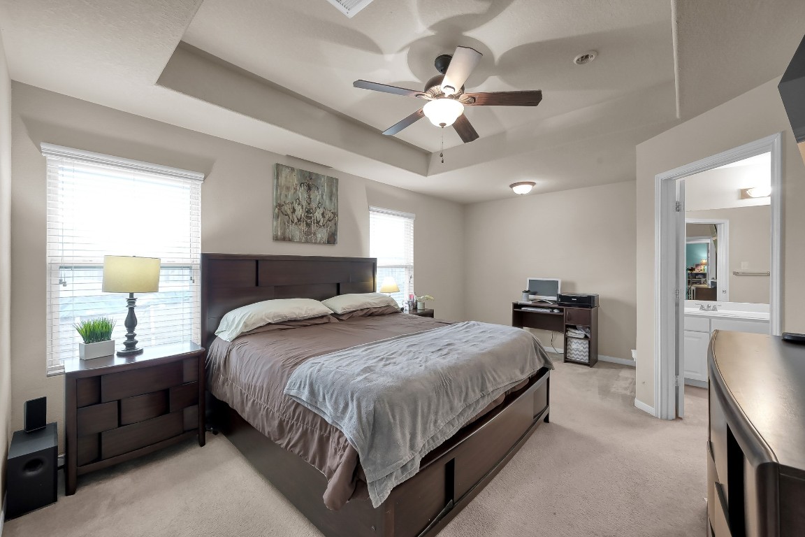 29341 Forest Floor Lane Spring, TX 77386 - Photo 18 of 41 a bedroom with a large bed and a chandelier
