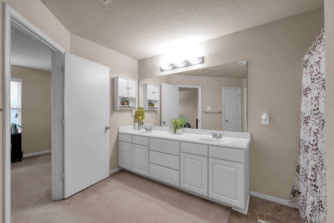 29341 Forest Floor Lane Spring, TX 77386 - Photo 22 of 41 a spacious bathroom with a double vanity sink and mirror
