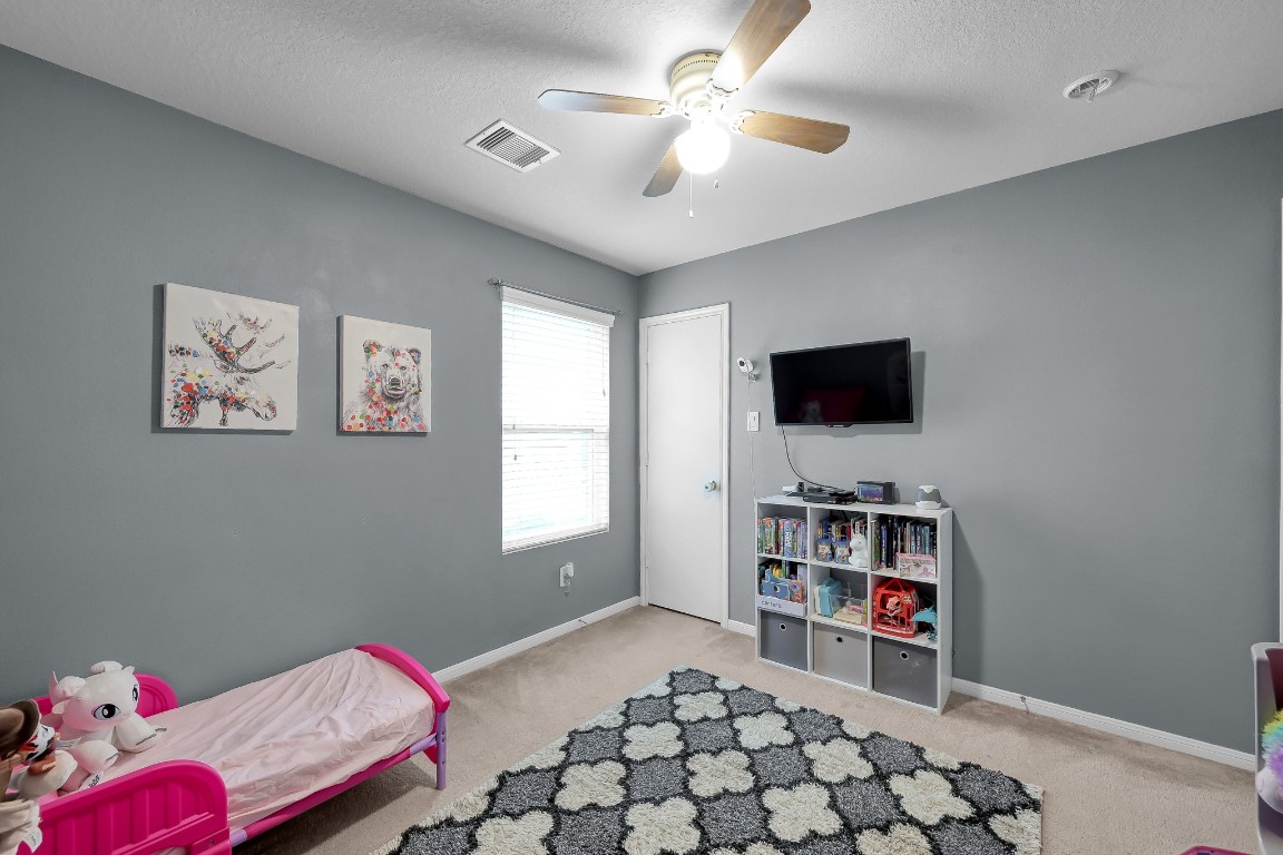 29341 Forest Floor Lane Spring, TX 77386 - Photo 29 of 41 a bedroom with furniture and a flat screen tv