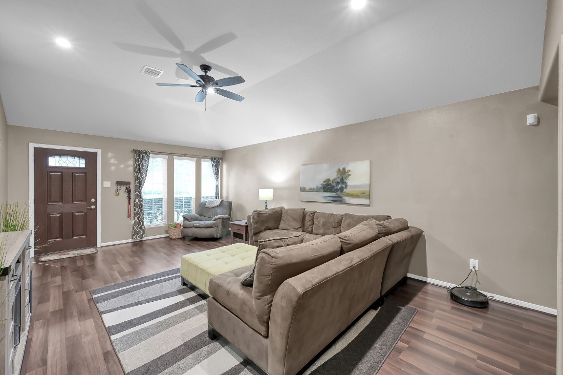 29341 Forest Floor Lane Spring, TX 77386 - Photo 6 of 41 a living room with furniture and a chandelier