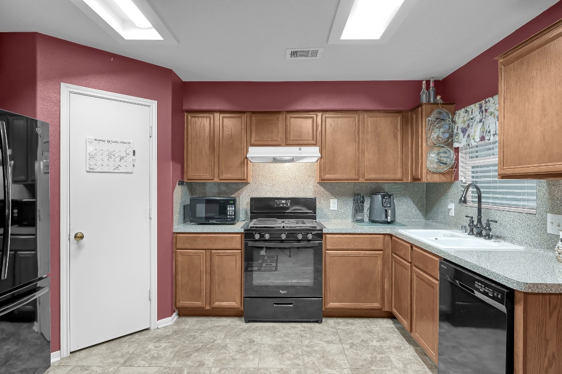 29341 Forest Floor Lane Spring, TX 77386 - Photo 9 of 41 a kitchen with a stove and a refrigerator