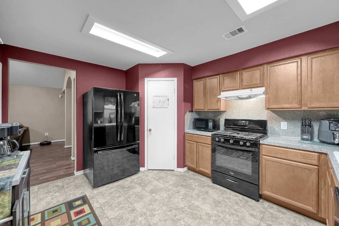 29341 Forest Floor Lane Spring, TX 77386 - Photo 10 of 41 a kitchen with stainless steel appliances granite countertop a stove a refrigerator and a sink