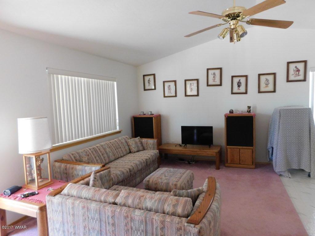 2749 Canyon Ridge Road Overgaard, AZ 85933 - Photo 15 of 25 a living room with furniture and a flat screen tv