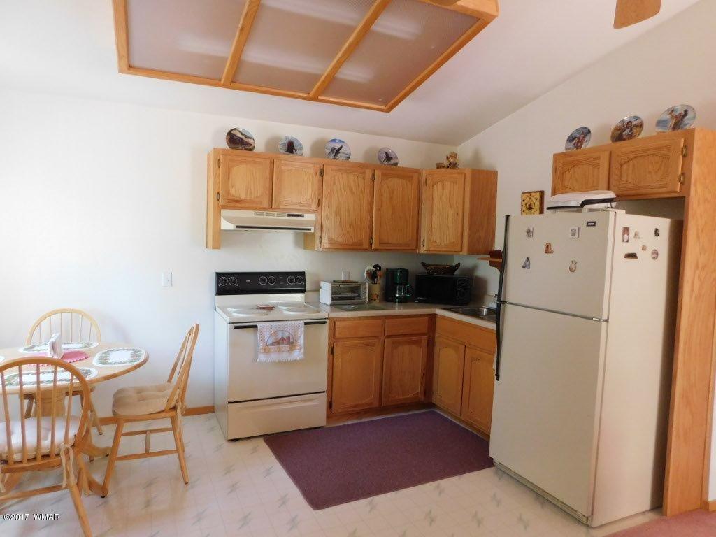 2749 Canyon Ridge Road Overgaard, AZ 85933 - Photo 18 of 25 a kitchen with a refrigerator a stove top oven a sink and dishwasher