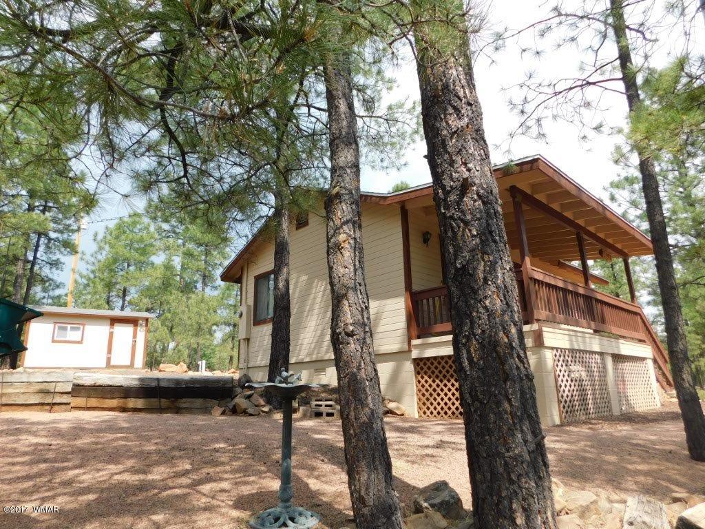2749 Canyon Ridge Road Overgaard, AZ 85933 - Photo 4 of 25 a view of a house with a tree next to a yard