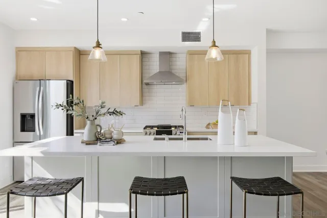 a kitchen with stainless steel appliances a sink and cabinets