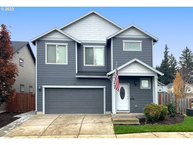 a front view of a house with a yard and garage