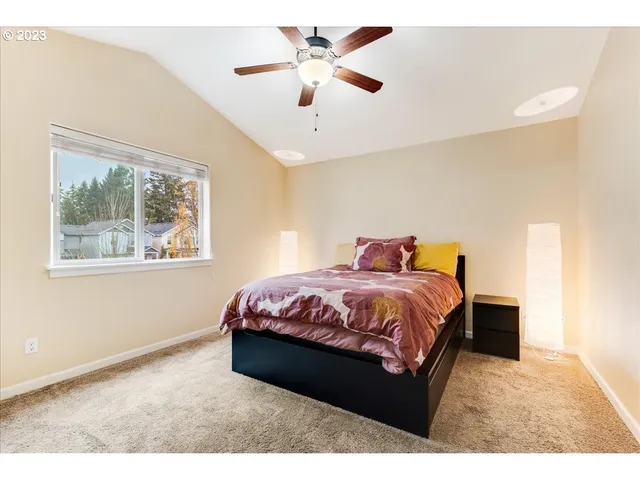 a bed sitting in a bedroom next to a window