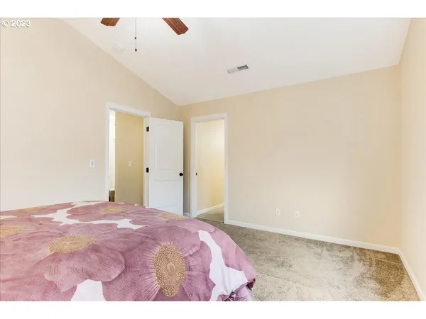 a bedroom with a bed and a painting on the wall