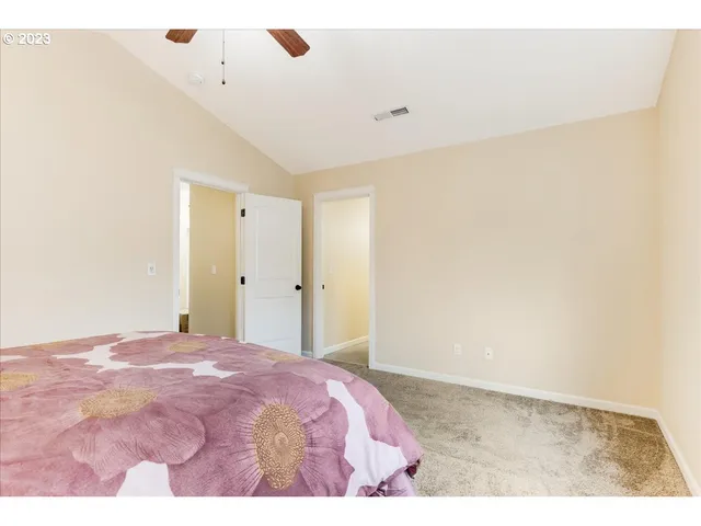 a bedroom with a bed and a painting on the wall