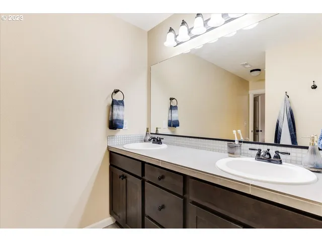 a bathroom with a sink vanity and a mirror