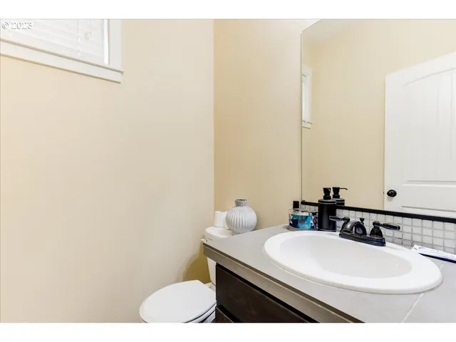 a bathroom with a sink vanity and a mirror